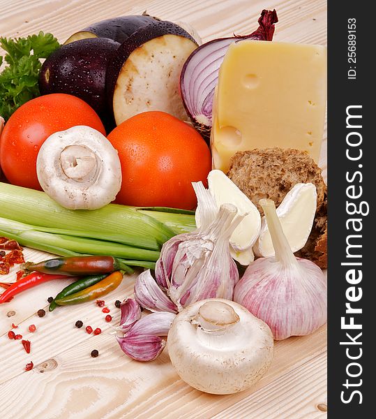 Ingredients and Vegetables with Cheese and Spices closeup on wooden background