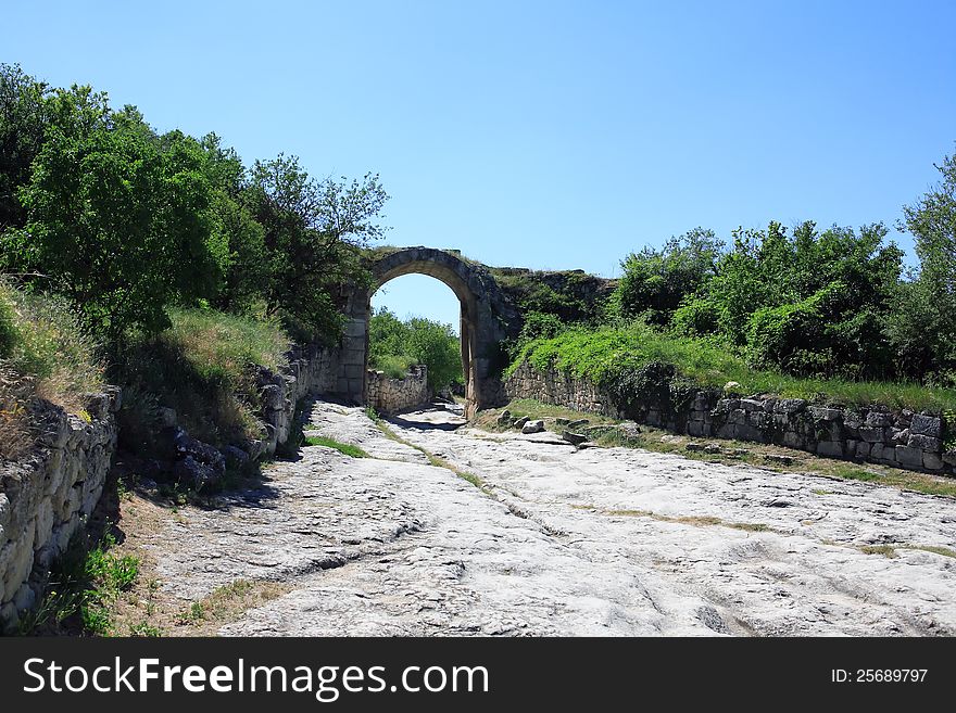 Road and arch stone gateway in ancient mountain settlement, Crimea. Road and arch stone gateway in ancient mountain settlement, Crimea