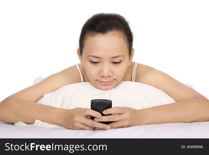 Asian woman send text message to her friend on the bed. Asian woman send text message to her friend on the bed