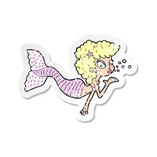 Retro Distressed Sticker Of A Cartoon Mermaid Blowing Kiss Royalty Free Stock Photography