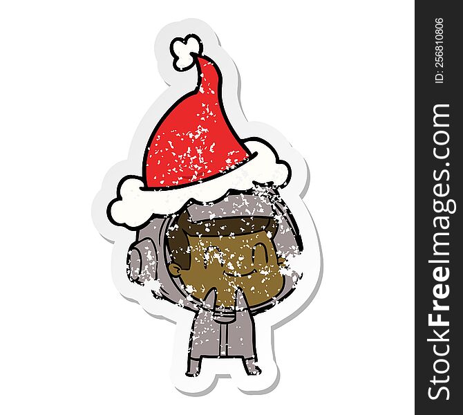 Happy Distressed Sticker Cartoon Of A Astronaut Wearing Santa Hat