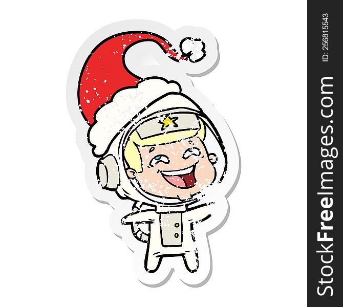 Distressed Sticker Cartoon Of A Laughing Astronaut Wearing Santa Hat