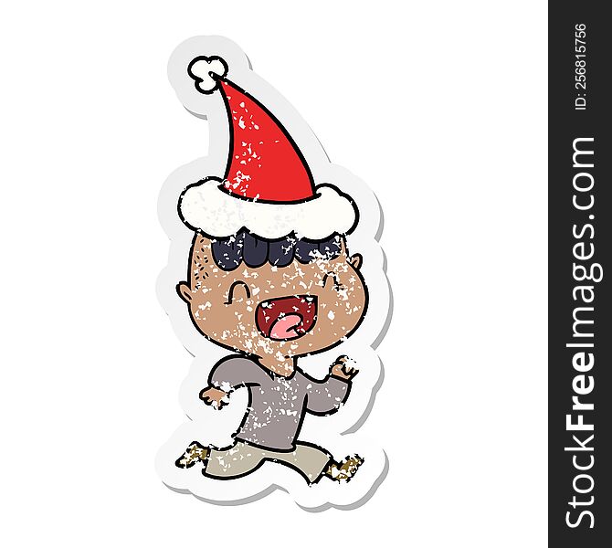 Distressed Sticker Cartoon Of A Happy Boy Laughing And Running Away Wearing Santa Hat