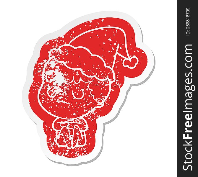 quirky cartoon distressed sticker of a grumpy boy wearing santa hat