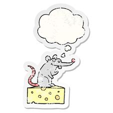 Cartoon Mouse Sitting On Cheese And Thought Bubble As A Distressed Worn Sticker Stock Photo