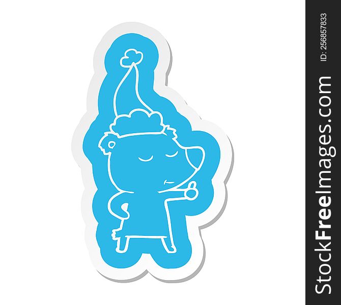 happy quirky cartoon  sticker of a bear giving thumbs up wearing santa hat