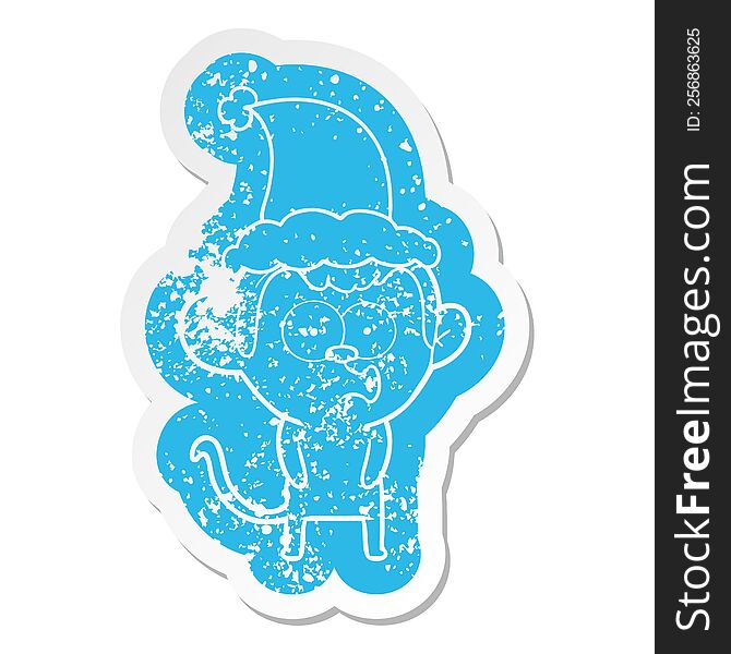 quirky cartoon distressed sticker of a hooting monkey wearing santa hat