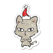 Distressed Sticker Cartoon Of A Cat Wearing Santa Hat Stock Photo