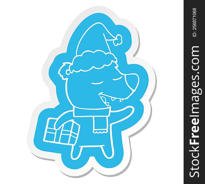 Cartoon  Sticker Of A Bear With Present Wearing Santa Hat