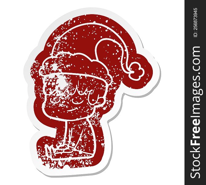 Cartoon Distressed Sticker Of A Happy Boy Wearing Santa Hat
