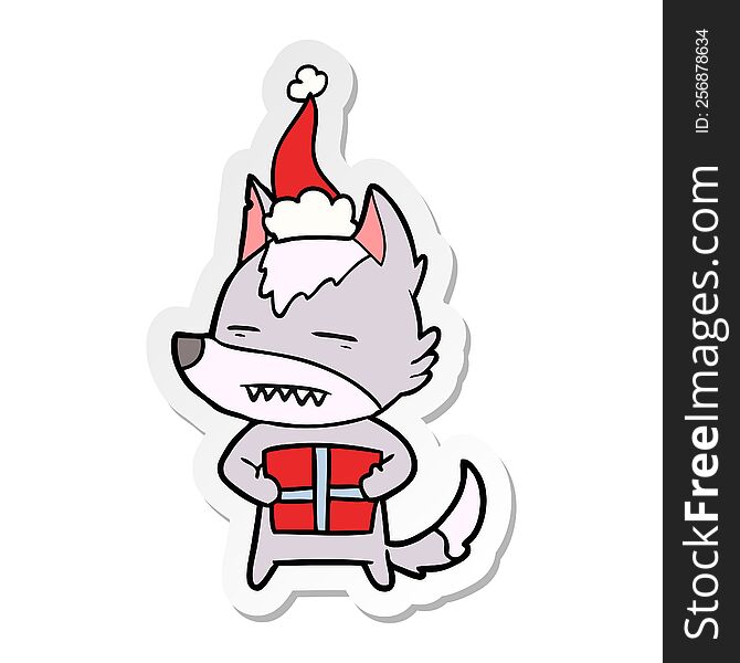 Sticker Cartoon Of A Wolf With A Gift Wearing Santa Hat