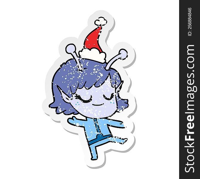 smiling alien girl hand drawn distressed sticker cartoon of a wearing santa hat