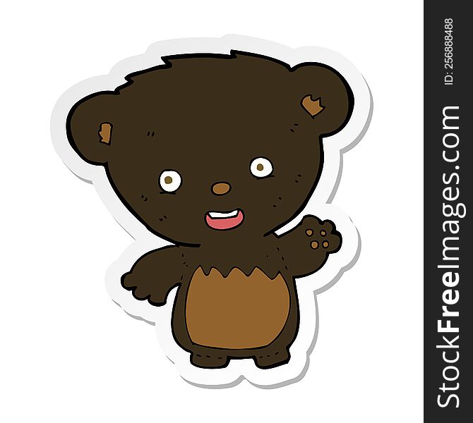 sticker of a cartoon black bearcub waving