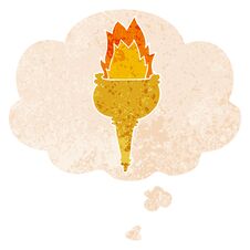 Cartoon Flaming Torch And Thought Bubble In Retro Textured Style Royalty Free Stock Photo
