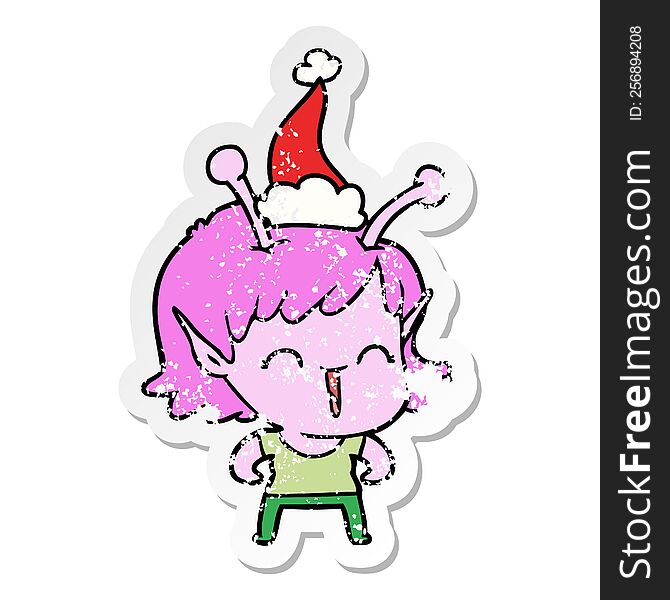 Distressed Sticker Cartoon Of A Alien Girl Laughing Wearing Santa Hat