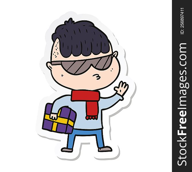 sticker of a cartoon boy wearing sunglasses carrying xmas gift