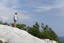 A Woman Stands High Above The Wilderness. Royalty Free Stock Photos A Woman Stands High Above The Wilderness. Royalty Free Stock Photos