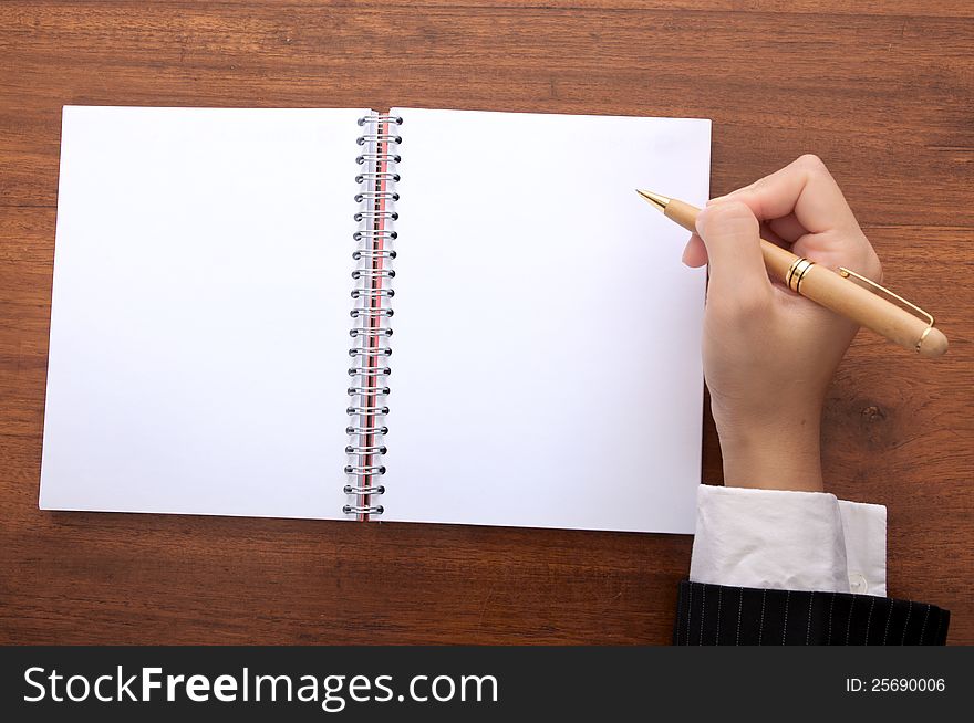 Business woman white something on blank notebook. Business woman white something on blank notebook