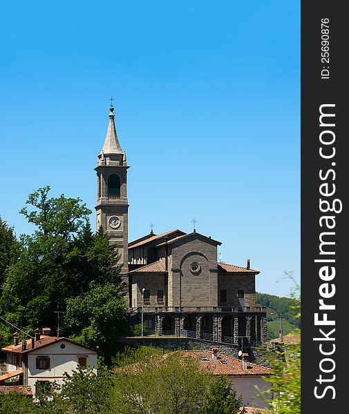 Small church with steeple in italian village