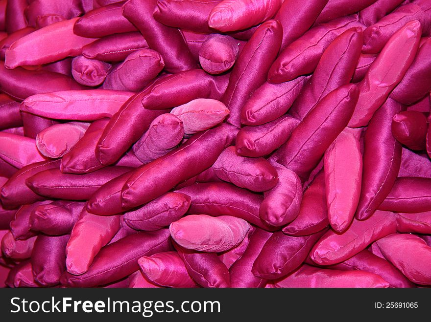 A Background of Sausage Shaped Purple Silk Bean Bags.