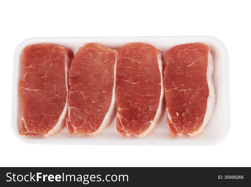 The pieces of raw fillet steaks in box isolated on white background