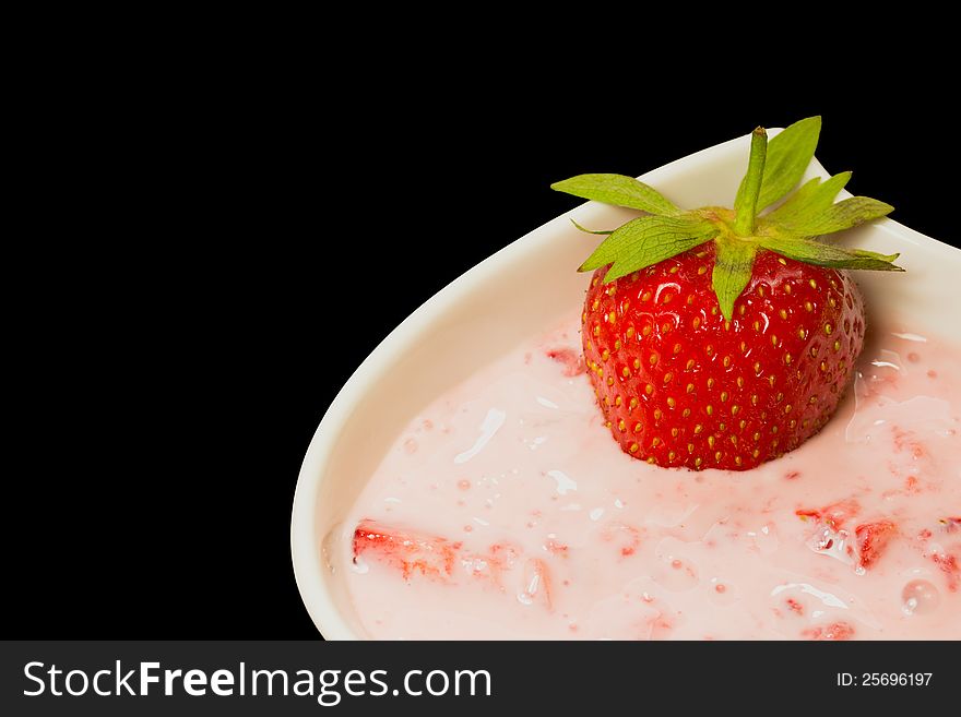 Fresh strawberry with cream . Black background.