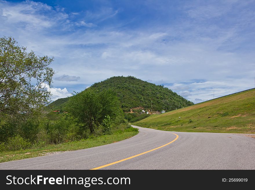 Road along reservoir and mountain