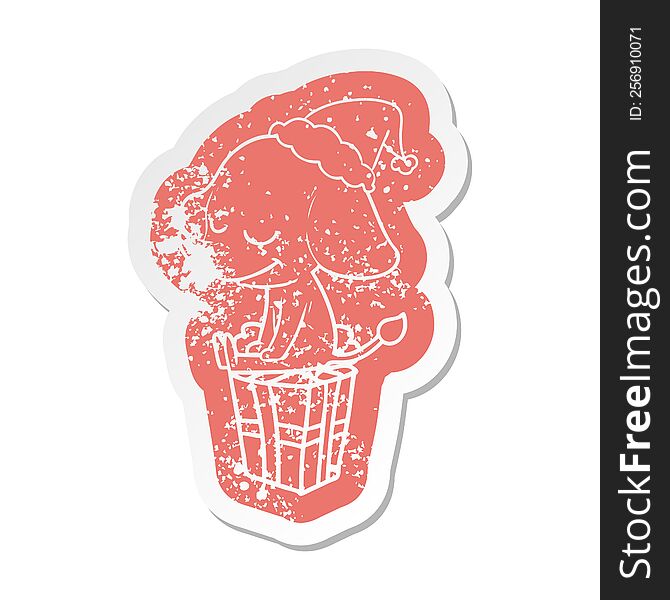 quirky cartoon distressed sticker of a smiling elephant wearing santa hat