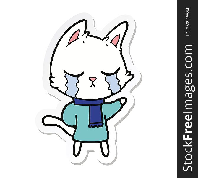 sticker of a crying cartoon cat wearing winter clothes