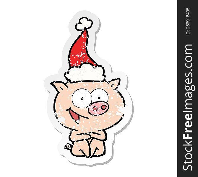 cheerful sitting pig distressed sticker cartoon of a wearing santa hat