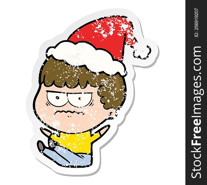 Distressed Sticker Cartoon Of A Annoyed Man Wearing Santa Hat