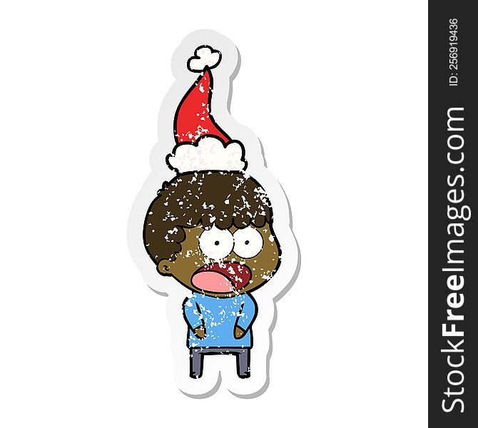 distressed sticker cartoon of a shocked man wearing santa hat