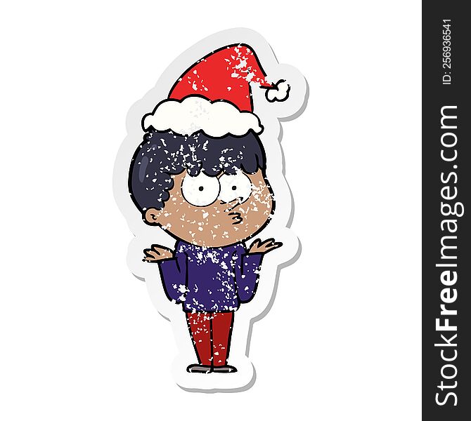 hand drawn distressed sticker cartoon of a curious boy shrugging shoulders wearing santa hat