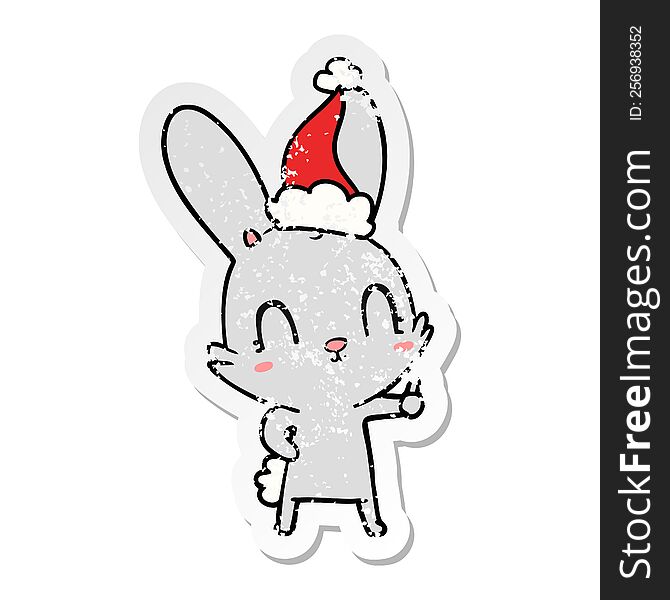 Cute Distressed Sticker Cartoon Of A Rabbit Wearing Santa Hat