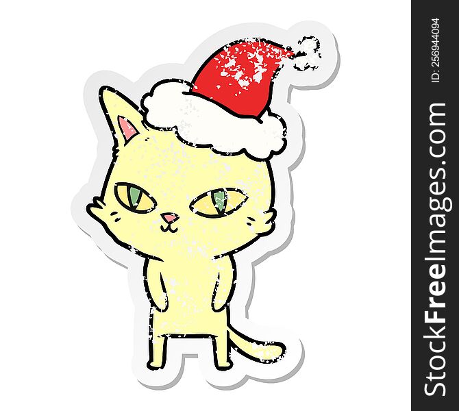 Distressed Sticker Cartoon Of A Cat With Bright Eyes Wearing Santa Hat