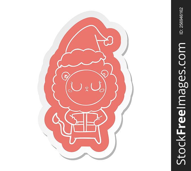 Cartoon  Sticker Of A Lion With Christmas Present Wearing Santa Hat