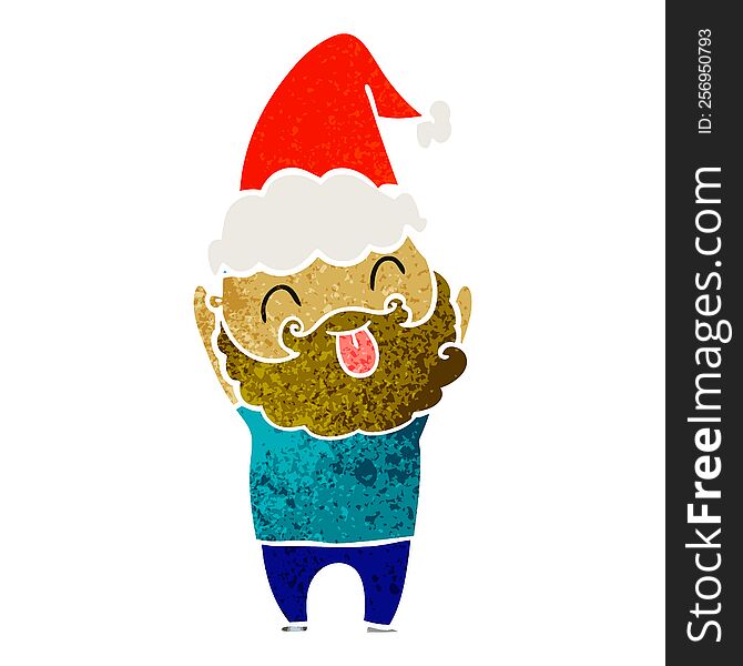 man with beard sticking out tongue wearing santa hat