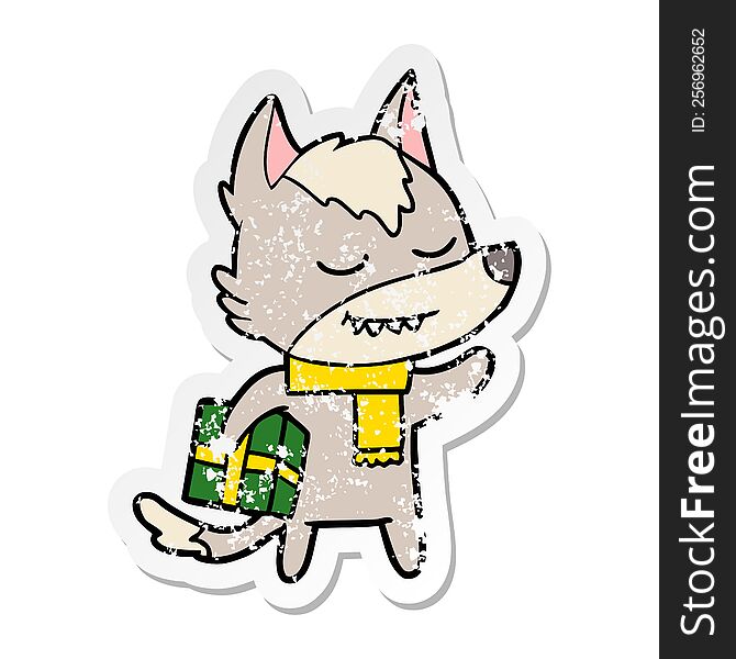 distressed sticker of a friendly cartoon wolf carrying christmas present