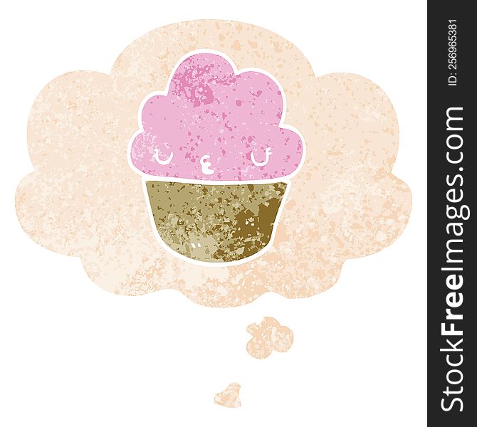 cartoon cupcake with face with thought bubble in grunge distressed retro textured style. cartoon cupcake with face with thought bubble in grunge distressed retro textured style