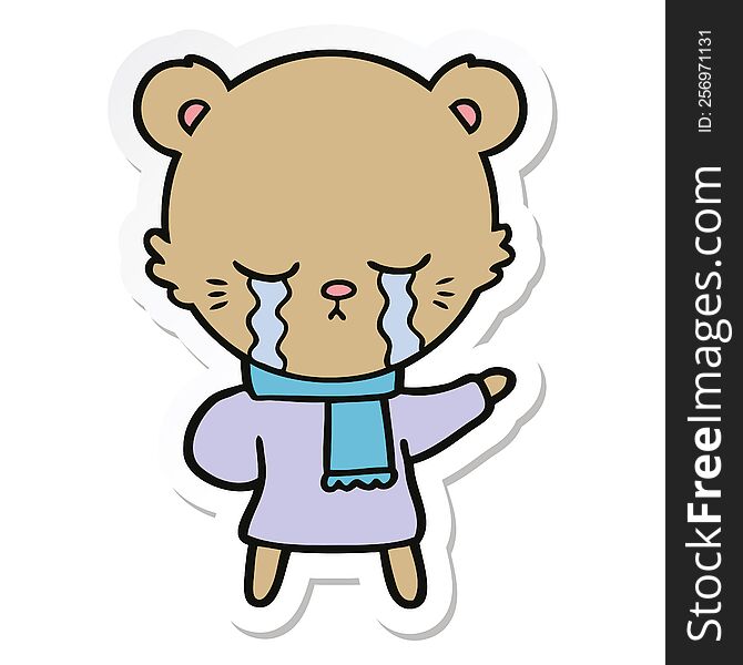 sticker of a crying cartoon bear wearing winter clothes