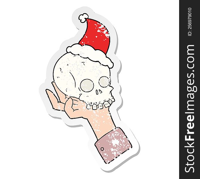 distressed sticker cartoon of a hand holding skull wearing santa hat