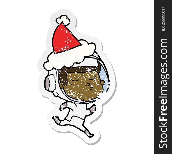 hand drawn distressed sticker cartoon of a confident astronaut wearing santa hat