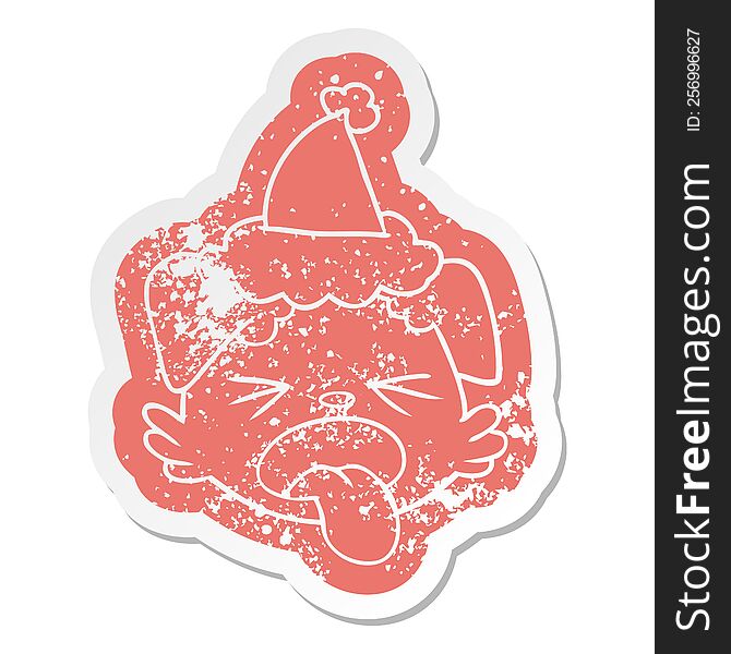 quirky cartoon distressed sticker of a dog face wearing santa hat