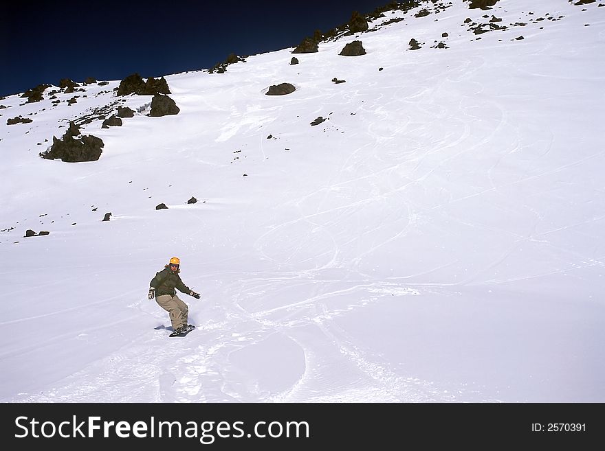 Girl riding snowboard on mountain's slope. Girl riding snowboard on mountain's slope