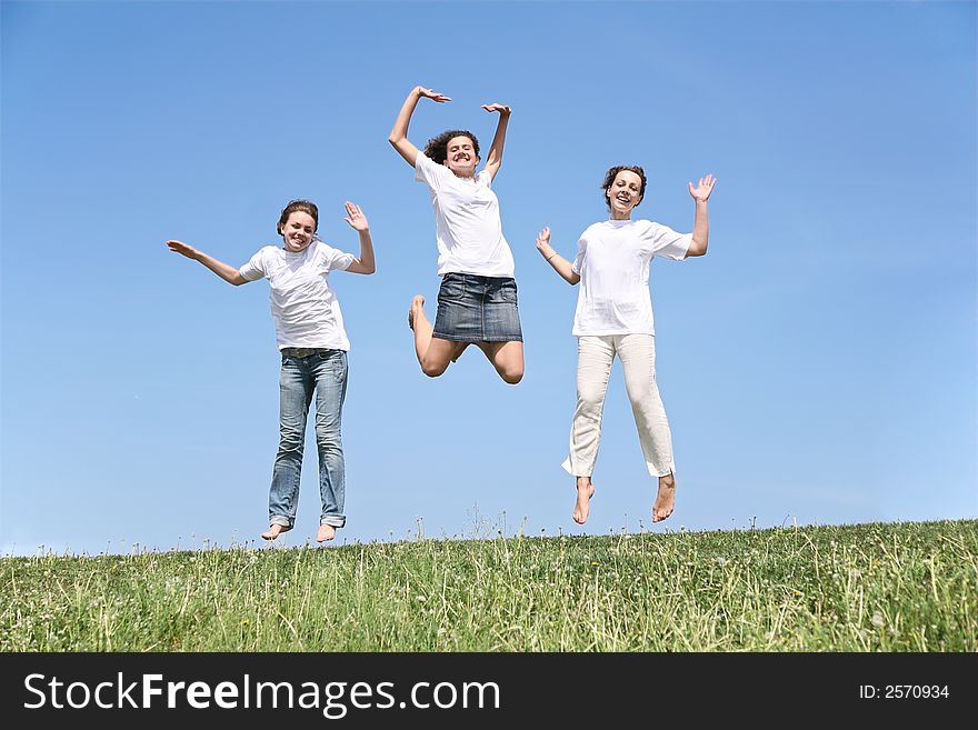 Three girlfriends in white T-shorts jump together