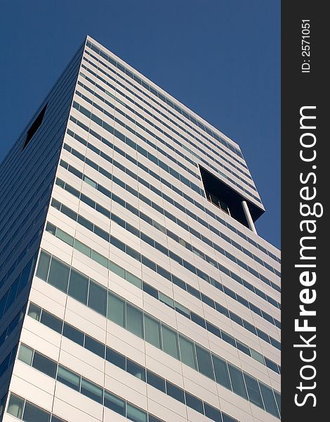 Tall office building, against a clear blue sky