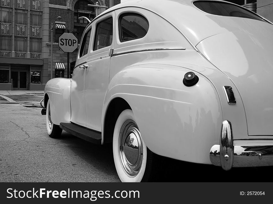 A black and white photo of parked vintage automobile