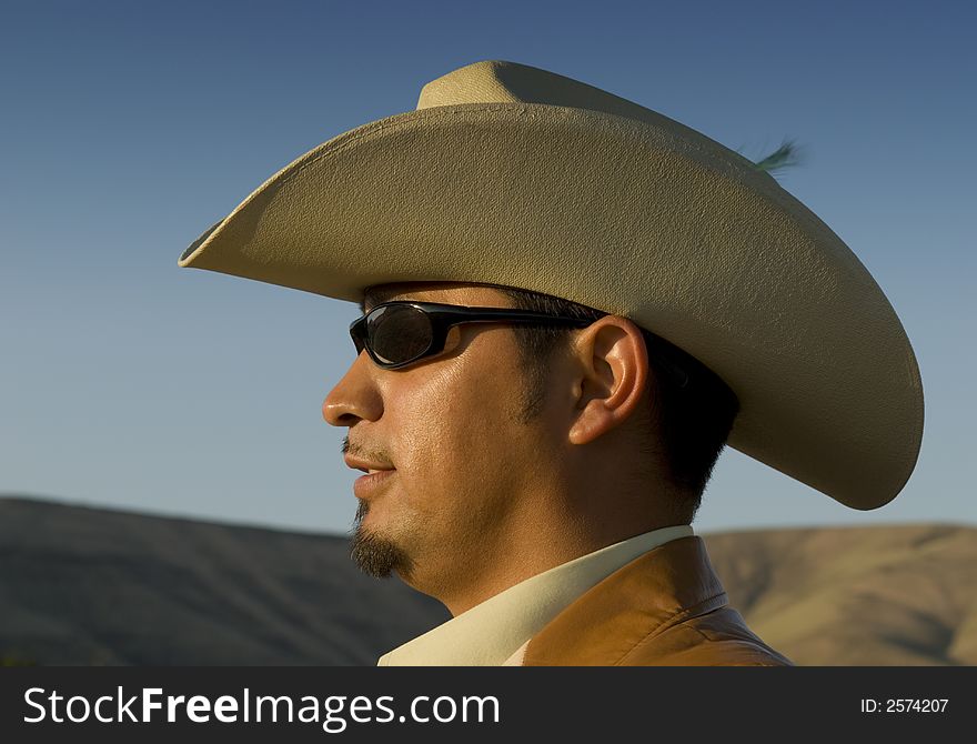 Profile head shot of a hispanic male with cowboy hat. Profile head shot of a hispanic male with cowboy hat