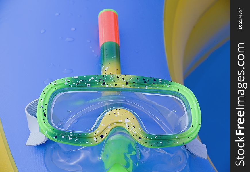 Multicolored diving googles with snorkel. Multicolored diving googles with snorkel