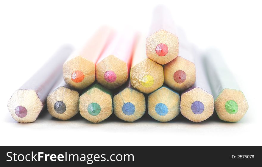 Colored wooden Crayons. Isolated on white background. Soft focus.